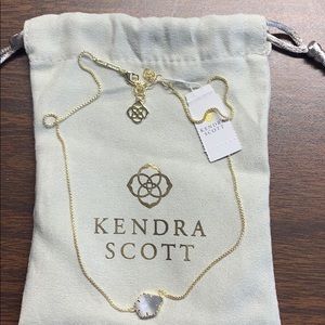 Kendra Scott necklace in gold with gray stone.